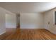 Inviting living room featuring hardwood floors, a front door, and ample natural light at 6176 Ammons St, Arvada, CO 80004