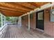 Covered patio with exposed rafters, leading to the home's back entry and backyard at 6176 Ammons St, Arvada, CO 80004