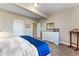 Bedroom showcasing neutral colors and a bed, dresser, and view to the outside at 17860 Calendula Dr, Parker, CO 80134