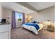 A simple bedroom features neutral colors, a bed, and a window with curtains at 17860 Calendula Dr, Parker, CO 80134