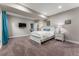 Serene bedroom with soft lighting, TV and minimalist decor for a peaceful retreat at 17860 Calendula Dr, Parker, CO 80134