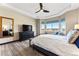 This bedroom features wood floors, a large window with views, and plenty of room at 17860 Calendula Dr, Parker, CO 80134