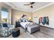 Bright bedroom with wood floors features a ceiling fan and large windows at 17860 Calendula Dr, Parker, CO 80134