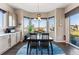 Cozy dining area featuring large windows, a modern light fixture, and seating for four at 17860 Calendula Dr, Parker, CO 80134