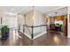 Inviting foyer with hardwood floors, staircase, and views into the dining room and entry at 17860 Calendula Dr, Parker, CO 80134