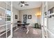 A contemporary home office featuring French doors, a ceiling fan, and space for productivity at 17860 Calendula Dr, Parker, CO 80134