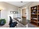 Comfortable home office with french doors, a modern desk, and a large bookshelf at 17860 Calendula Dr, Parker, CO 80134