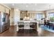 Bright kitchen featuring stainless steel appliances, a center island, and hardwood floors at 17860 Calendula Dr, Parker, CO 80134