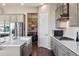 Kitchen featuring stainless steel appliances, a large island, and light-colored cabinets at 17860 Calendula Dr, Parker, CO 80134