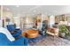 Bright living room connects to kitchen, featuring hardwood floors and stylish modern furniture at 17860 Calendula Dr, Parker, CO 80134