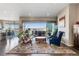 Bright living room with hardwood floors, a fireplace, and a balcony overlooking a scenic view at 17860 Calendula Dr, Parker, CO 80134