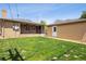 Spacious backyard features a well-maintained lawn and brick buildings at 4780 E Montana Pl, Denver, CO 80222