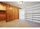 Basement area with wood paneling, carpet, and built-in shelving at 4780 E Montana Pl, Denver, CO 80222