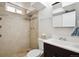 Bathroom with tiled shower, modern fixtures, and vanity with storage at 4780 E Montana Pl, Denver, CO 80222