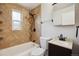 Updated bathroom with mosaic tile accents, shower and tub, modern fixtures, and vanity at 4780 E Montana Pl, Denver, CO 80222