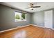 Bright bedroom featuring hardwood floors, fresh paint, ceiling fan, and a sunlit window at 4780 E Montana Pl, Denver, CO 80222