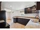 Updated kitchen featuring dark wood cabinets, granite countertops, and tile flooring and backsplash at 4780 E Montana Pl, Denver, CO 80222