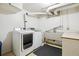 Functional laundry room with sink, washer, dryer, and ample space at 4780 E Montana Pl, Denver, CO 80222