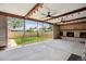 Covered patio with ceiling fans, fireplace, and backyard view at 4780 E Montana Pl, Denver, CO 80222