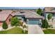 Beautiful home with manicured lawn, complemented by a large driveway and lush landscaping at 817 Backcountry Ln, Highlands Ranch, CO 80126