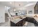 Finished basement with a bar area, granite countertops, and a staircase leading to the upper level at 817 Backcountry Ln, Highlands Ranch, CO 80126