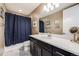Well-lit bathroom with sleek vanity, modern mirror, and shower with a navy curtain at 817 Backcountry Ln, Highlands Ranch, CO 80126