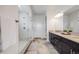 This pristine bathroom boasts dual vanities, a glass-enclosed shower, and modern fixtures and finishes at 817 Backcountry Ln, Highlands Ranch, CO 80126