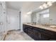 Luxury bathroom boasts a modern dual sink vanity, glass-enclosed shower, and modern finishes at 817 Backcountry Ln, Highlands Ranch, CO 80126