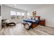 Bright primary bedroom featuring a large bed, chaise lounge, and three windows with views at 817 Backcountry Ln, Highlands Ranch, CO 80126