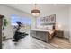 Beautiful bedroom features large windows, stylish lighting, and luxury gray wood flooring at 817 Backcountry Ln, Highlands Ranch, CO 80126