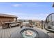 Stylish deck with a fire pit, comfortable seating, and scenic views of the neighborhood and mountains at 817 Backcountry Ln, Highlands Ranch, CO 80126