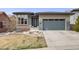 Beautiful home exterior with a manicured lawn, rock accents, and a two-car garage at 817 Backcountry Ln, Highlands Ranch, CO 80126