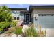 Charming home featuring a modern front door, well-maintained landscaping, and beautiful blue siding at 817 Backcountry Ln, Highlands Ranch, CO 80126