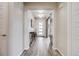 Inviting hallway with modern lighting and a decorative console table with wood-look tile floors at 817 Backcountry Ln, Highlands Ranch, CO 80126