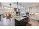 Modern kitchen with granite countertops and a large island featuring pendant lighting and stainless steel appliances at 817 Backcountry Ln, Highlands Ranch, CO 80126