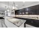 Modern kitchen with granite countertops, custom cabinetry, and stainless steel appliances at 817 Backcountry Ln, Highlands Ranch, CO 80126