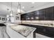 The modern kitchen showcases a large granite island and sleek cabinetry, ideal for cooking and gathering at 817 Backcountry Ln, Highlands Ranch, CO 80126