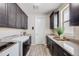 Laundry room featuring a washer, dryer, and storage cabinets at 817 Backcountry Ln, Highlands Ranch, CO 80126