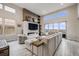 Open living area with tall windows, contemporary fireplace and shelving, and light colored hardwood flooring at 817 Backcountry Ln, Highlands Ranch, CO 80126