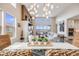 Open concept living space with high ceilings, fireplace, view windows, and a glimpse into the kitchen at 817 Backcountry Ln, Highlands Ranch, CO 80126