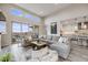 Spacious living room featuring a large sectional sofa and a view into the modern kitchen at 817 Backcountry Ln, Highlands Ranch, CO 80126