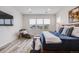 Bright main bedroom featuring large windows, a plush chaise lounge, and modern decor at 817 Backcountry Ln, Highlands Ranch, CO 80126