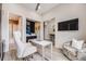 Comfortable home office featuring a white desk, large chair, and television at 817 Backcountry Ln, Highlands Ranch, CO 80126