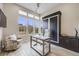 Stylish home office with large windows, a Murphy bed, and a modern desk setup at 817 Backcountry Ln, Highlands Ranch, CO 80126