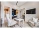 Functional home office with a view into the bathroom and featuring a ceiling fan and wall-mounted TV at 817 Backcountry Ln, Highlands Ranch, CO 80126