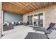 Covered patio with comfortable seating and lounge chairs, ideal for enjoying the outdoors in any weather at 817 Backcountry Ln, Highlands Ranch, CO 80126