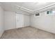 Basement featuring carpeted floors, white walls, exposed ductwork, and a white door at 4001 S Acoma St, Englewood, CO 80110