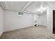 Basement featuring carpeted floors and white-painted walls and exposed ceiling at 4001 S Acoma St, Englewood, CO 80110