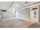 Basement with white ceiling, exposed pipes, and partial wood-paneled wall at 4001 S Acoma St, Englewood, CO 80110