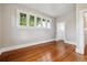 Bright bedroom featuring hardwood floors and a large window offering natural light at 4001 S Acoma St, Englewood, CO 80110